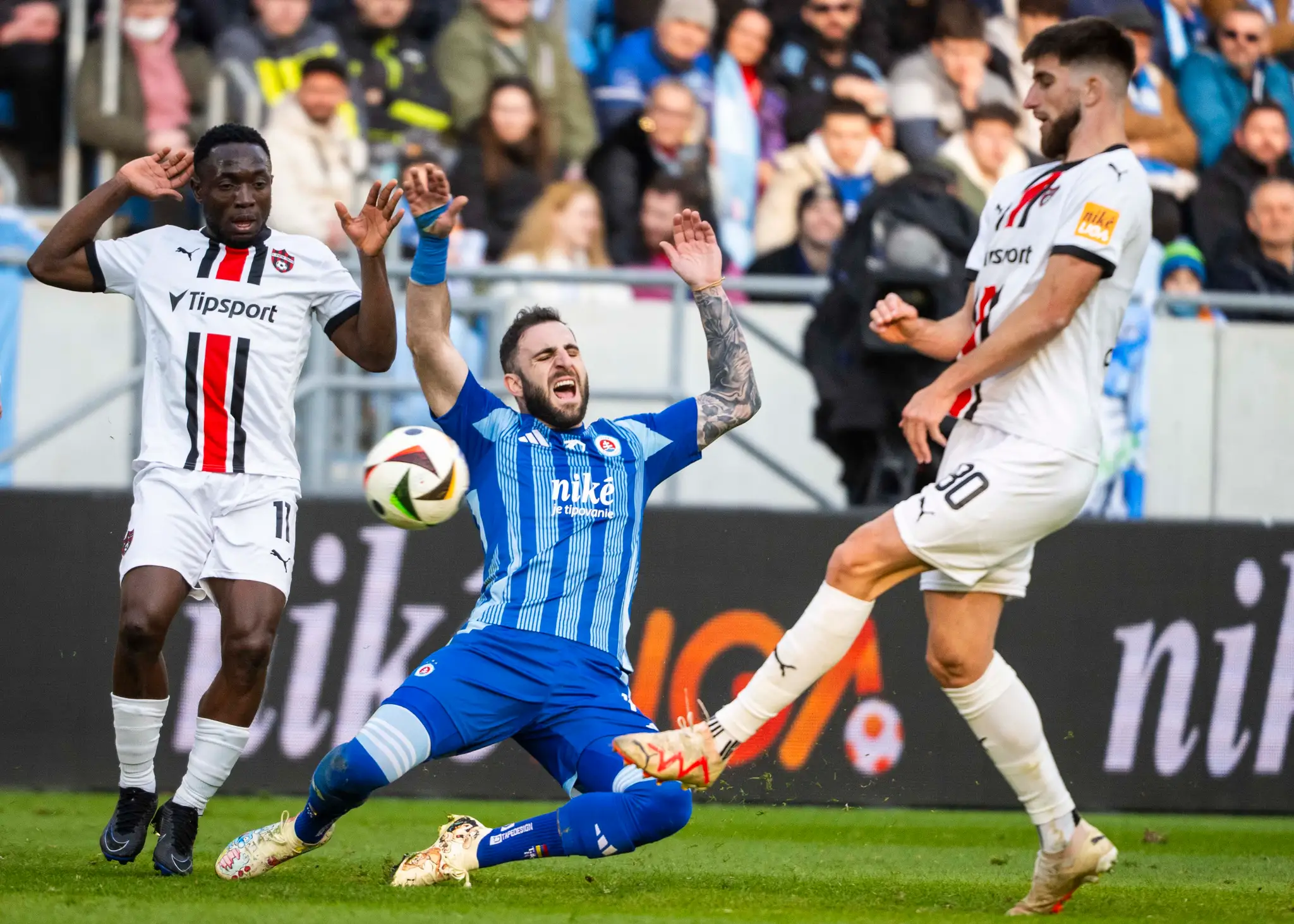 Na snímke zľava Philip Azango (Trnava), Tigran Barseghjan (Slovan) a Adrian Zeljkovič (Trnava).