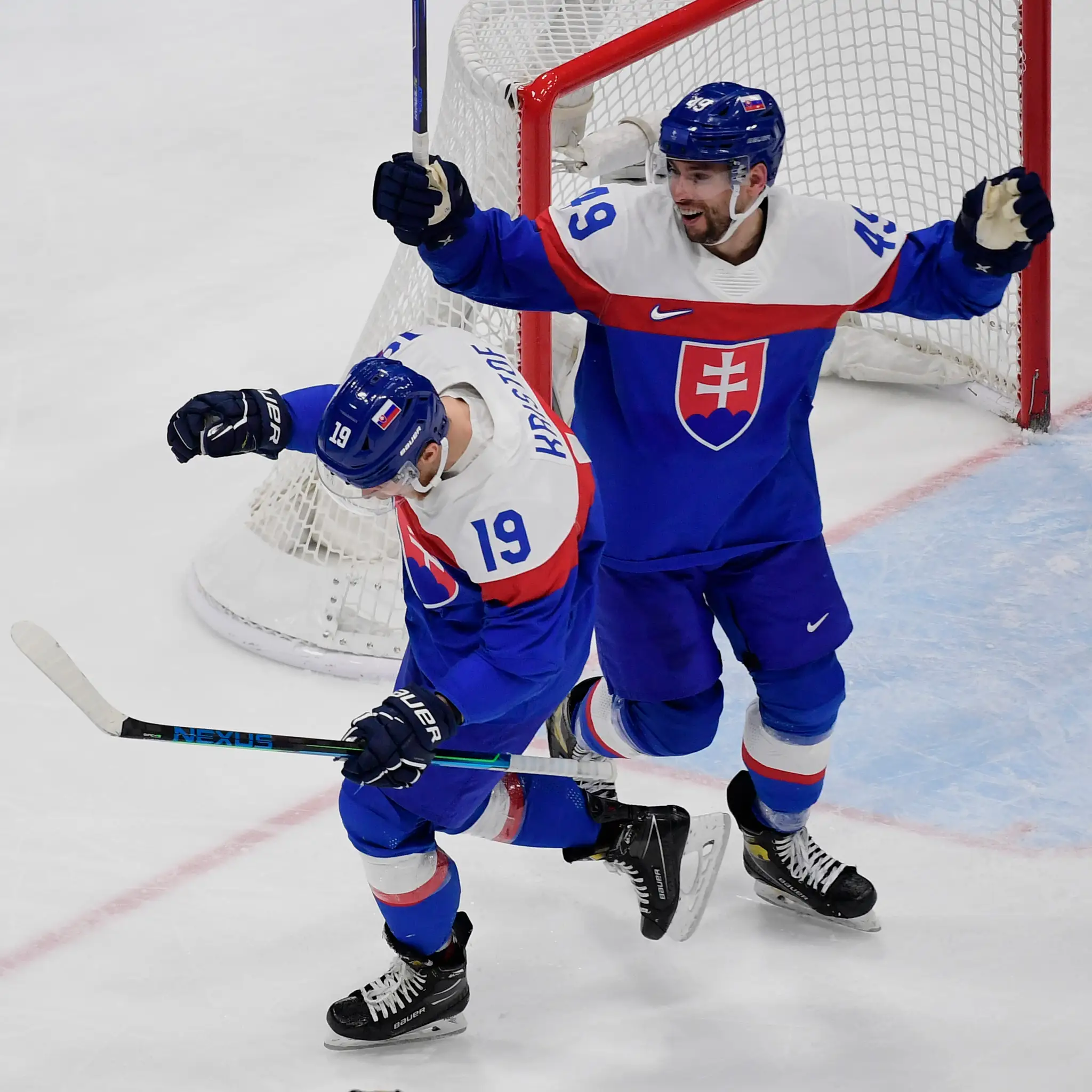 Slovenský hokejista Michal Krištof (vľavo) sa teší z gólu so spoluhráčom Samuelom Takáčom v kvalifikácii ZOH 2022 proti Nemecku.