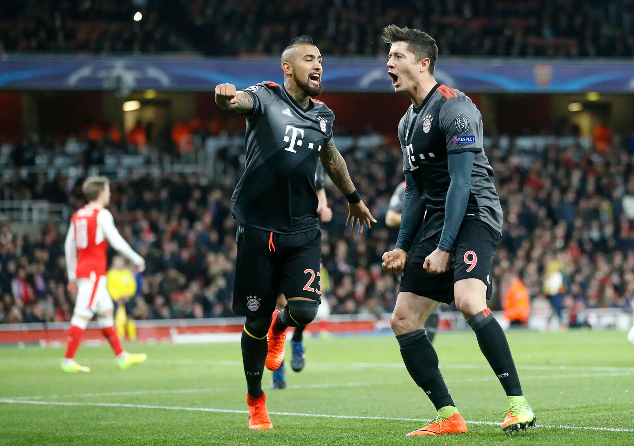 Robert Lewandowski (vpravo) z Bayernu oslavuje gól s Arturom Vidalom v osemfinále LM.