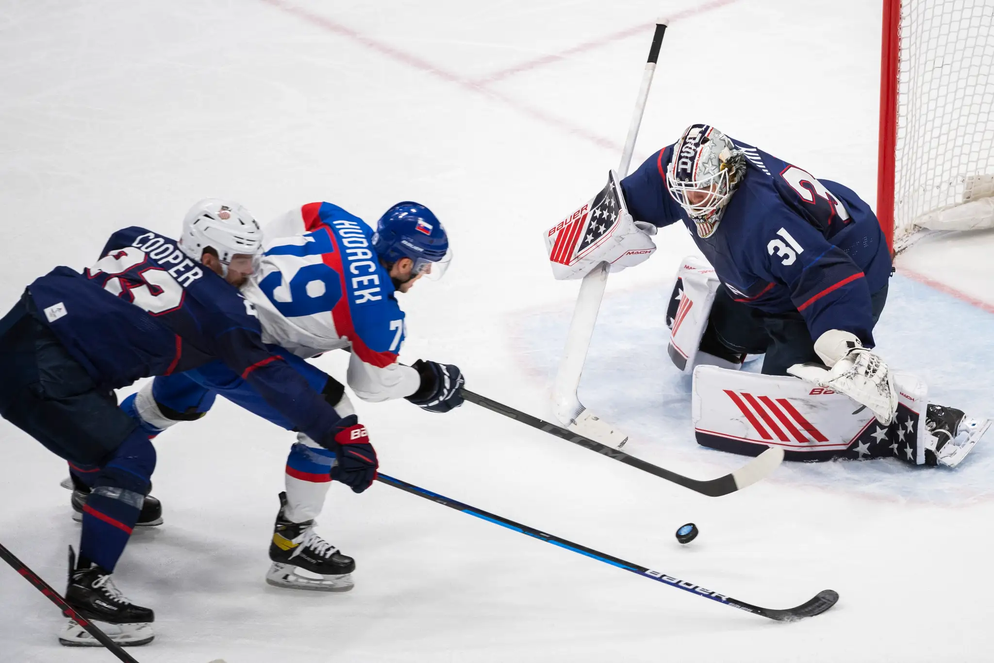 Zľava Američan Brian Cooper, Libor Hudáček a gólman USA Strauss Mann vo štvrťfinále ZOH 2022.