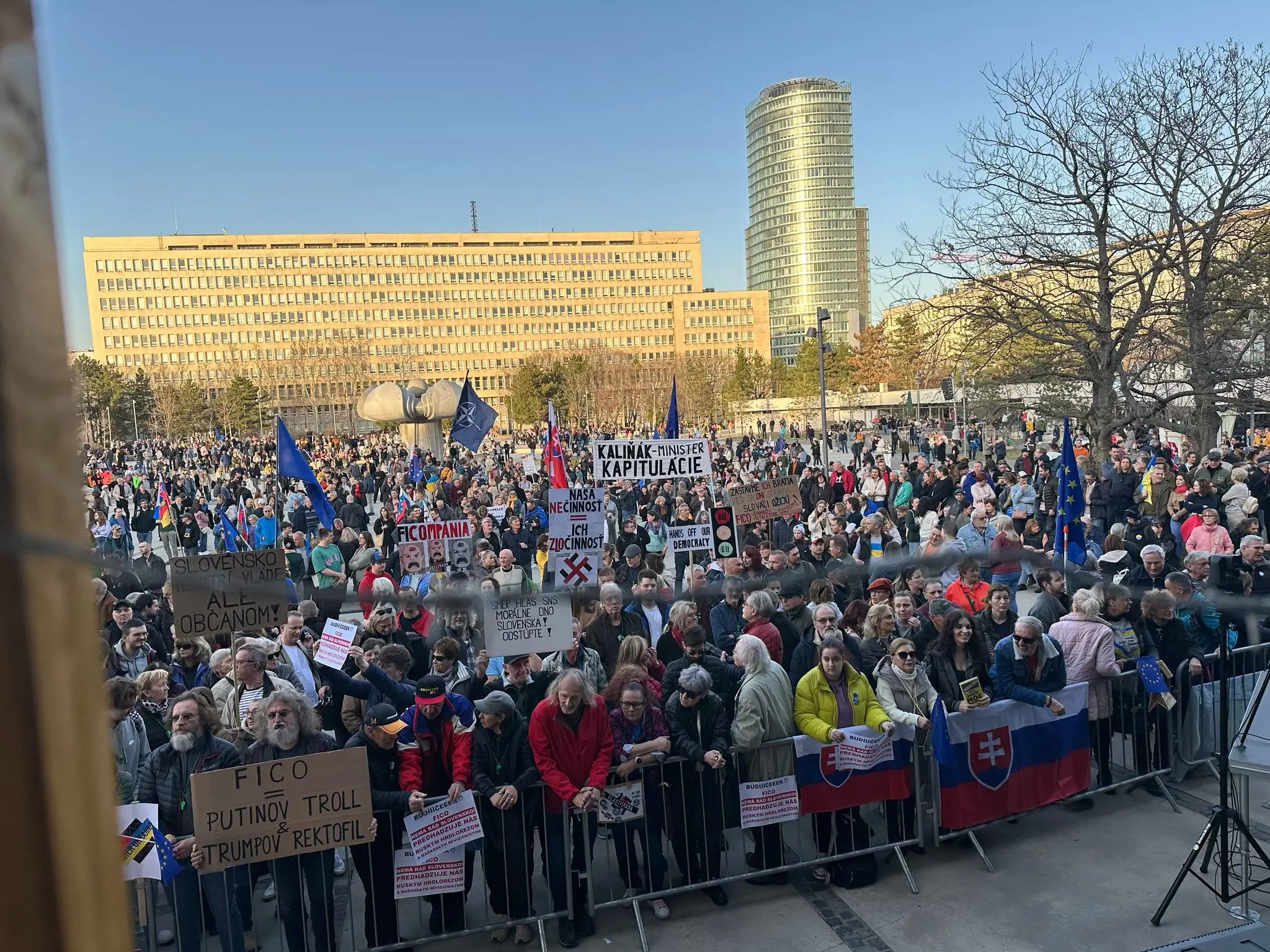 Protestujúci s vlajkami a transparentami