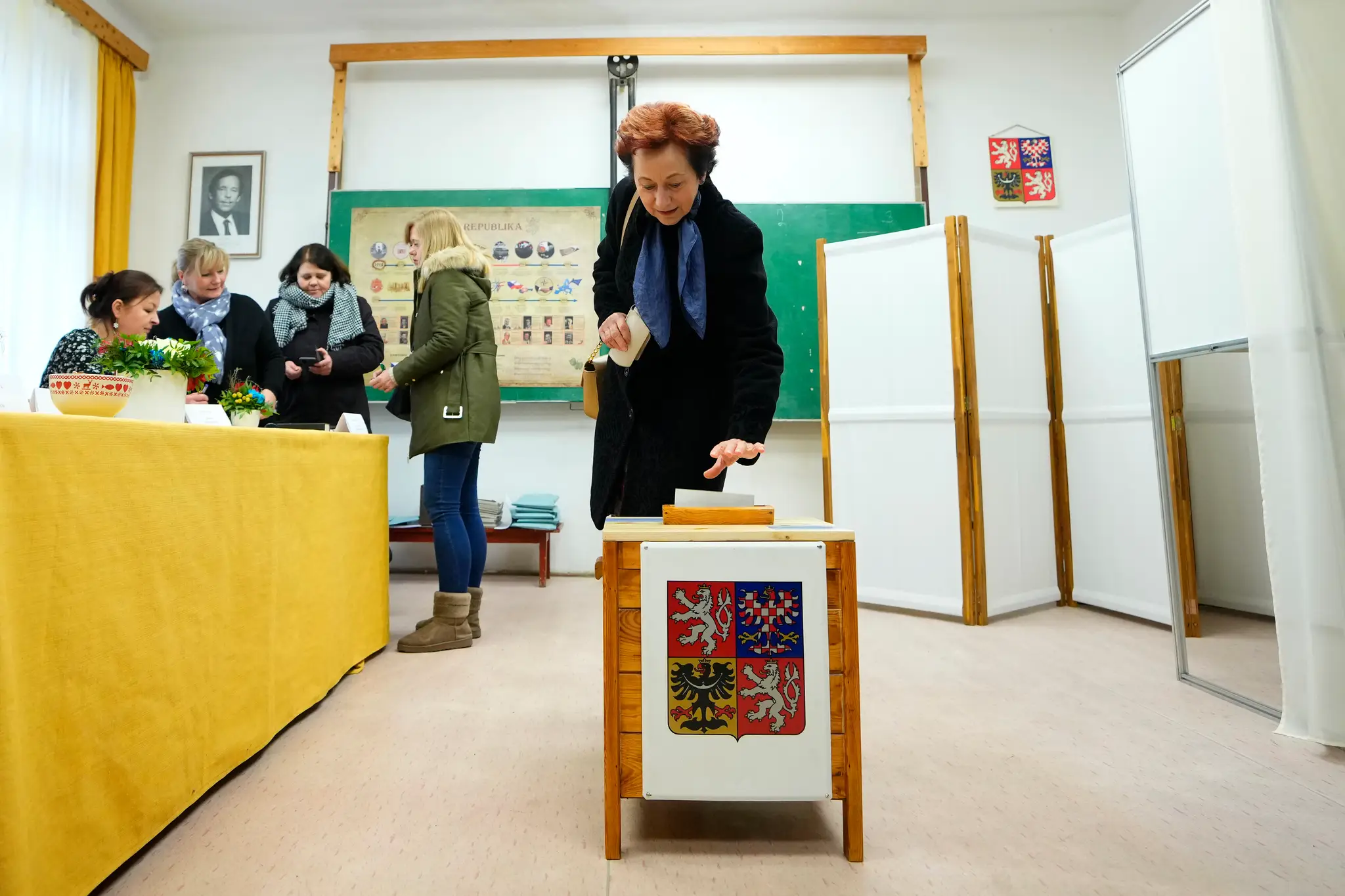 Volička vkladá hlasovací lístok do volebnej schránky počas druhého kola prezidentských volieb vo volebnej miestnosti v českej obci Černouček