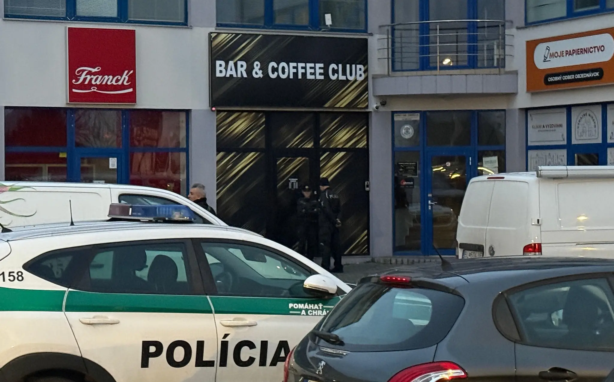 Policajti pred barom.
