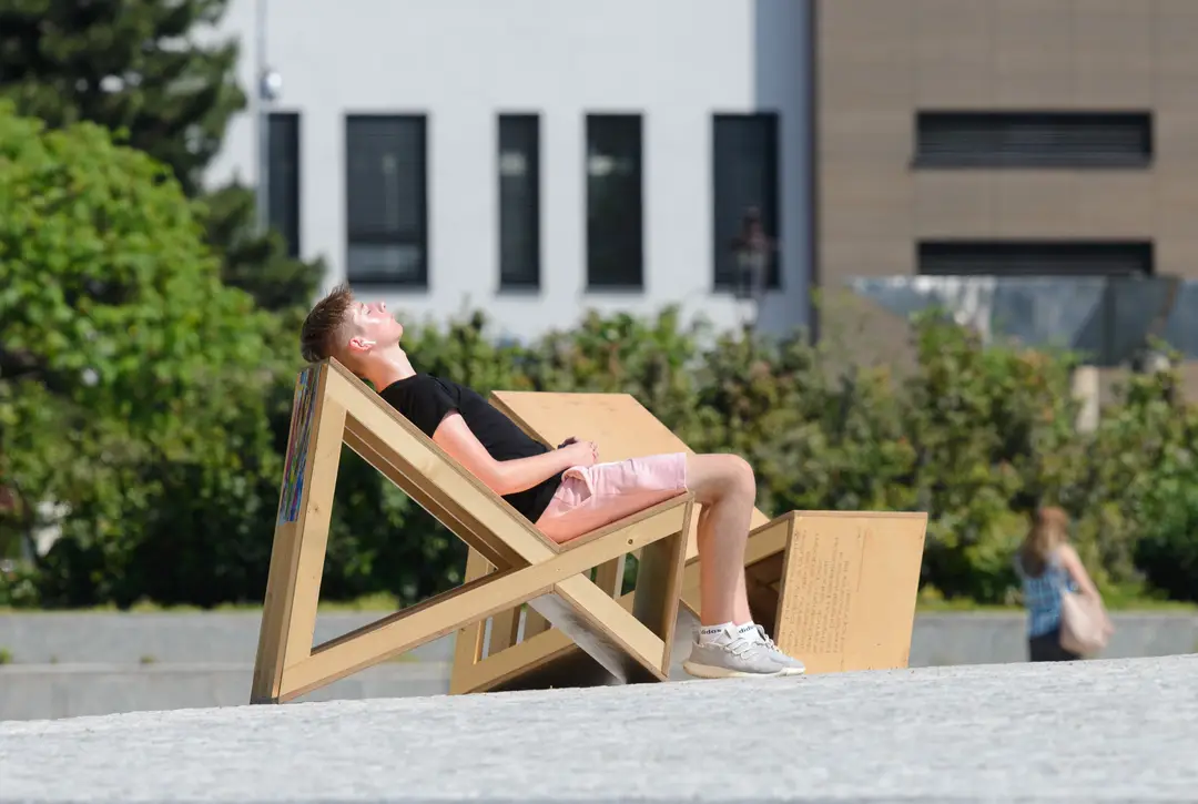 Chlapec sa slní na Svätoplukovom námestí počas horúceho dňa v Nitre.