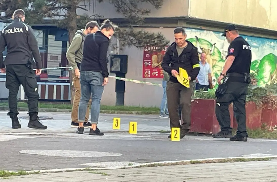 Policajti označujú miesto po streľbe.