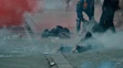 Zranení demonštranti ležia na hodníku po zásahu polície.