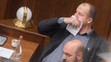 Peter Krupa si prekrýva tvár papierovou vreckovkou a dole Andrej Medvecký (obaja ĽSNS).