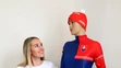 Paulína Bátovská Fialková stojí pri novej reprezentačnej kombinéze počas tlačovej konferencie Slovenského zväzu biatlonu.