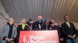 Kandidát na prezidenta SR Peter Pellegrini (uprostred) reaguje na predbežné neoficiálne výsledky po sčítaní 98 percent hlasov vo svojej volebnej centrále.