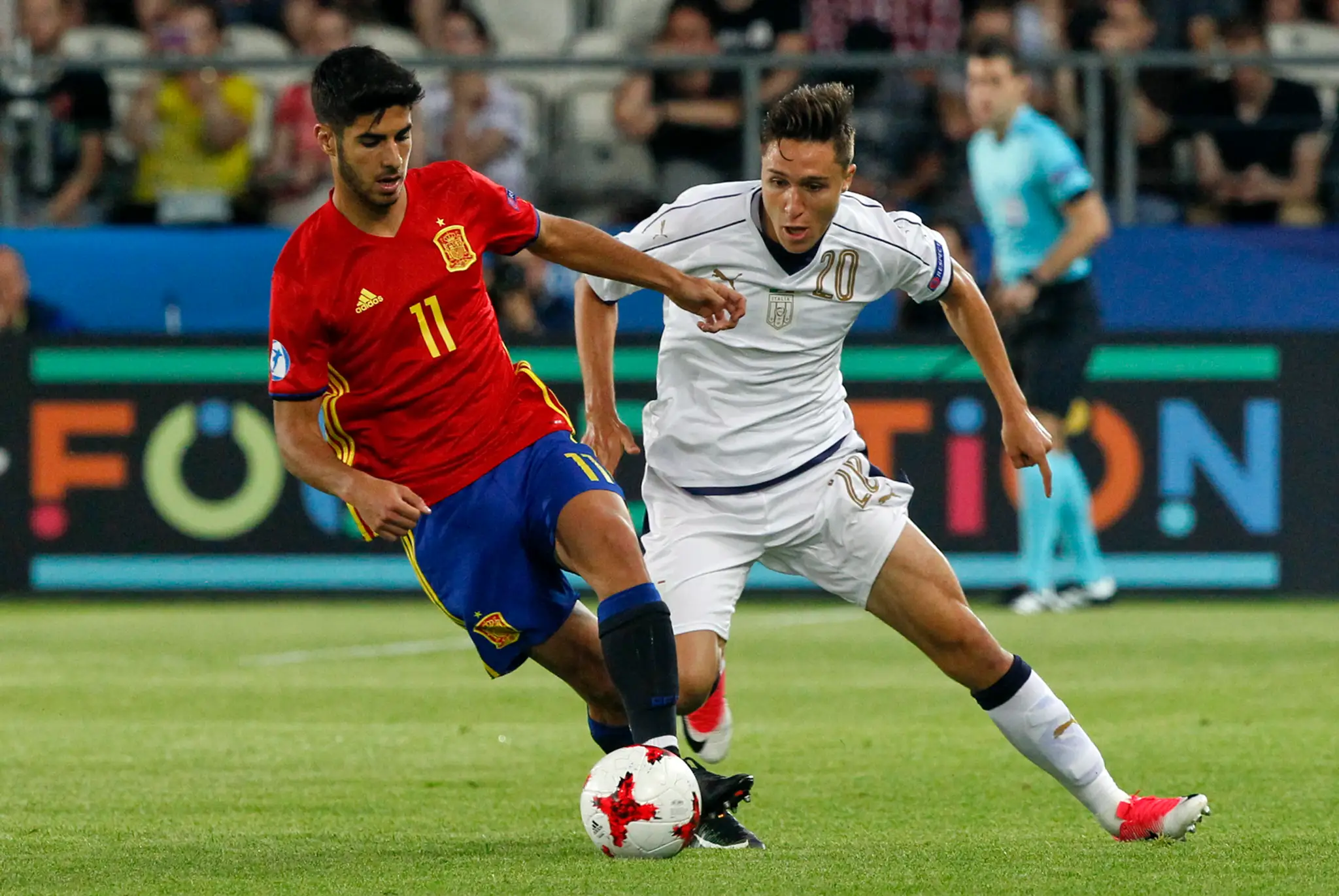 Marco Asensio (vľavo) zo Španielskabojuje o loptu s Talianom Federicom Chiesom v semifinále ME 21.