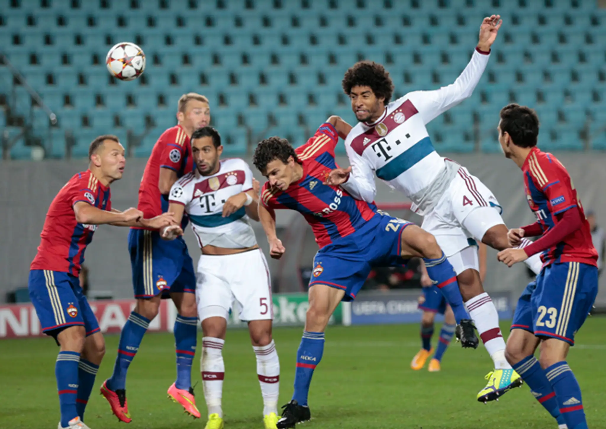 Hráč Bayernu Dante (druhý sprava) v zápase LM pred prázdnym hľadiskom CSKA Moskva
