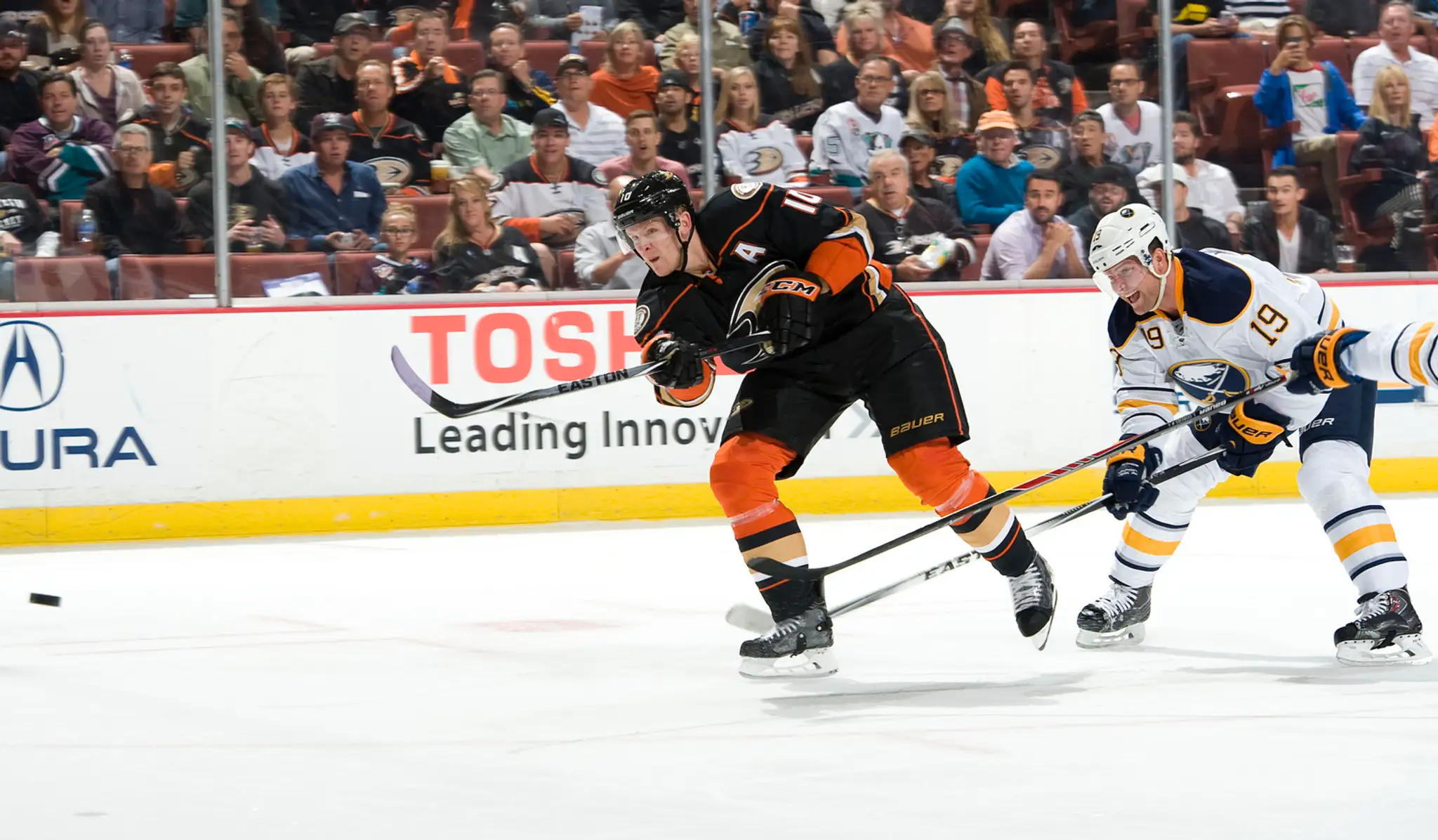Corey Perry (Ducks) strieľa gól stíhaný Cody Hodgsonom (Sabres) v zápase Anaheim - Buffalo (4:1).