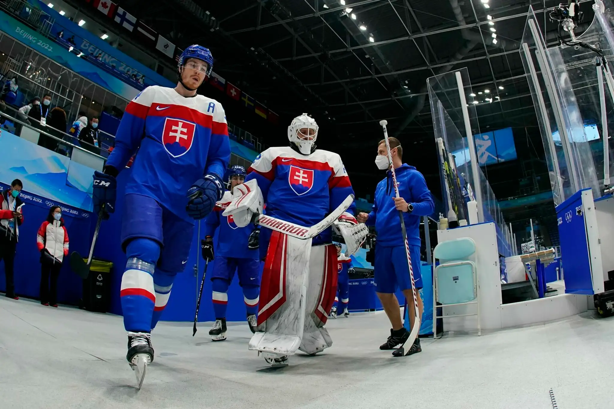 Hráči Slovenska vstupujú na ľad pred duelom proti Lotyšsku na ZOH 2022.