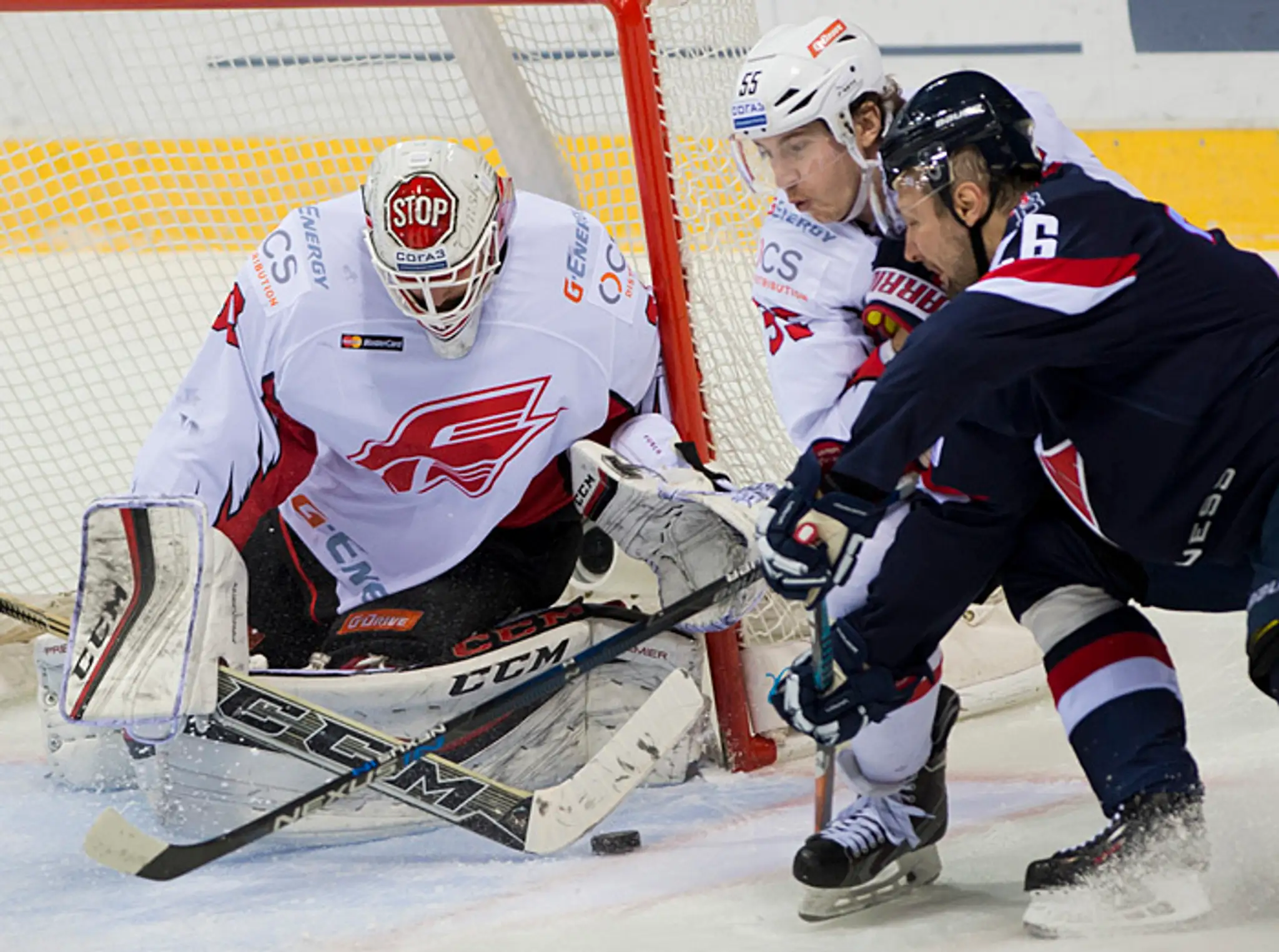 Igor Musatov (Slovan), Jegor Martynov a brankár Dominik Furth (obaja Omsk).