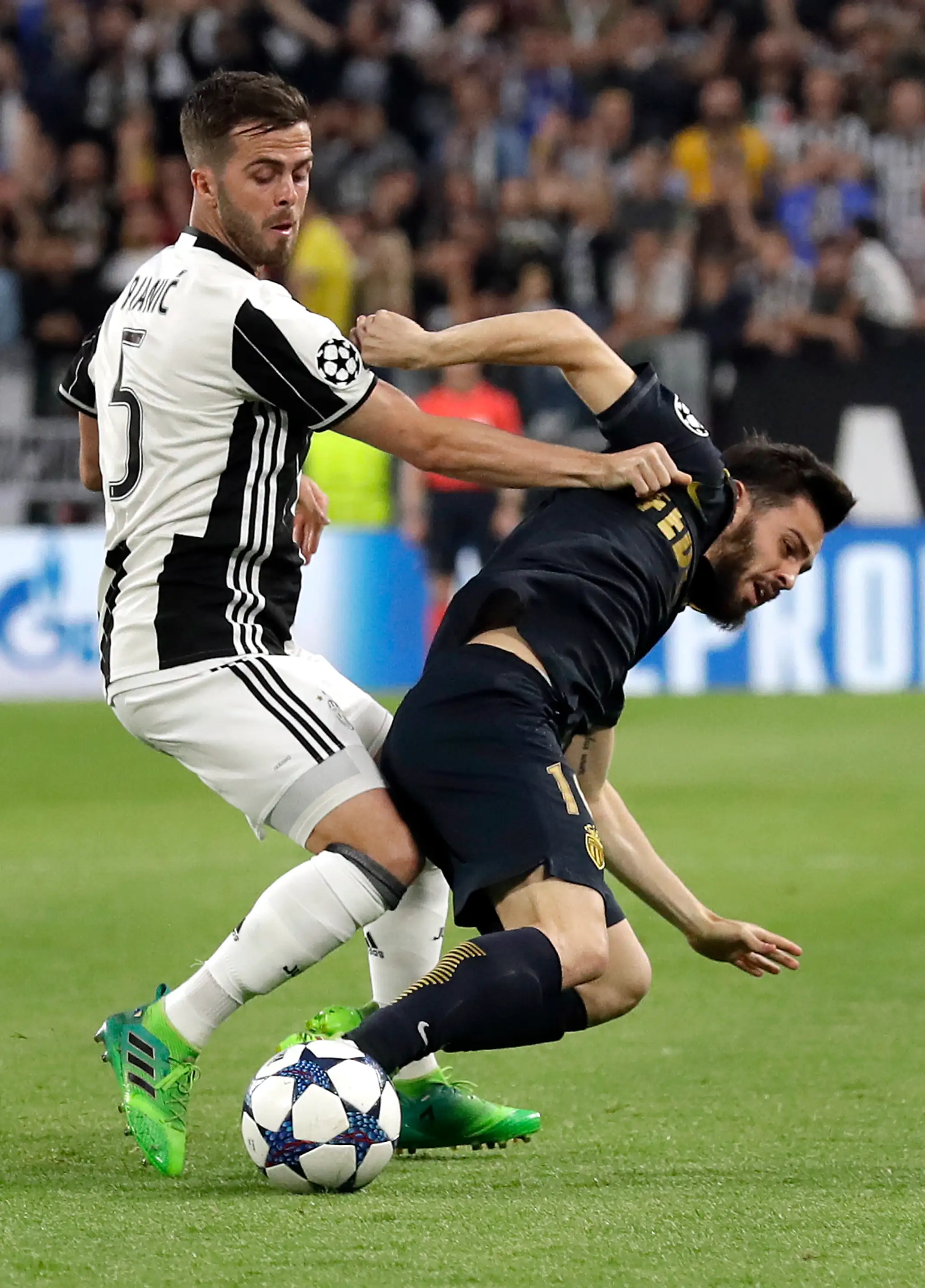 Dani Alves (vľavo) z Juventusu srdnato bojuje o loptu s Benjaminom Mendym z Monaca v odvete semifinále LM.
