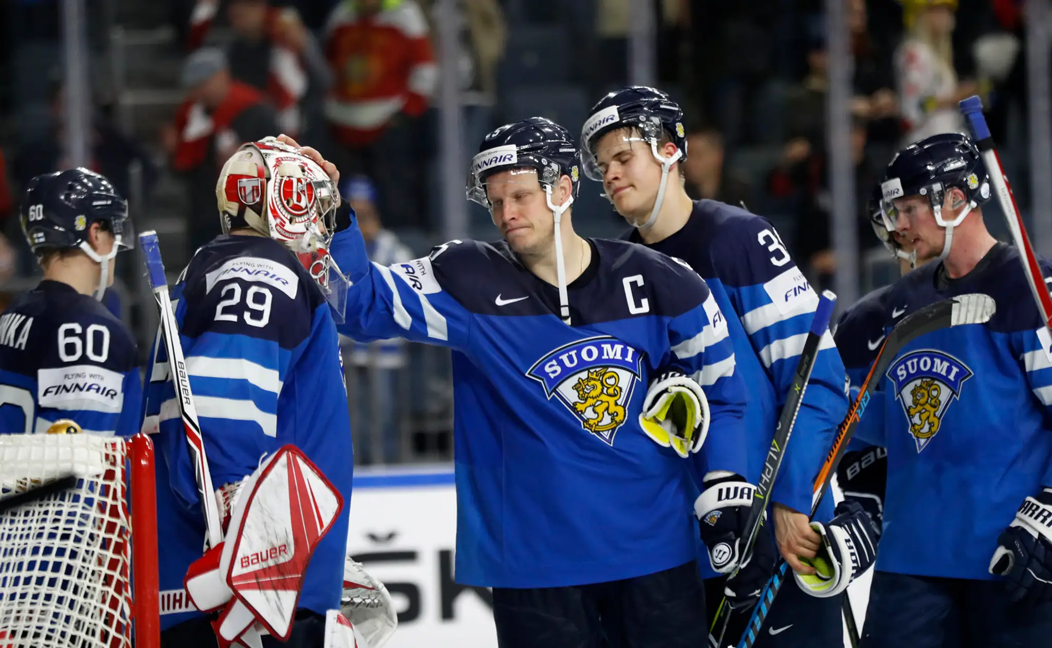 Fínsky kapitán Lasse Kukkonen (v strede) utešuje spoluhráča Harriho Säteriho (vľavo) po prehratom semifinále MS 2017 proti Švéds