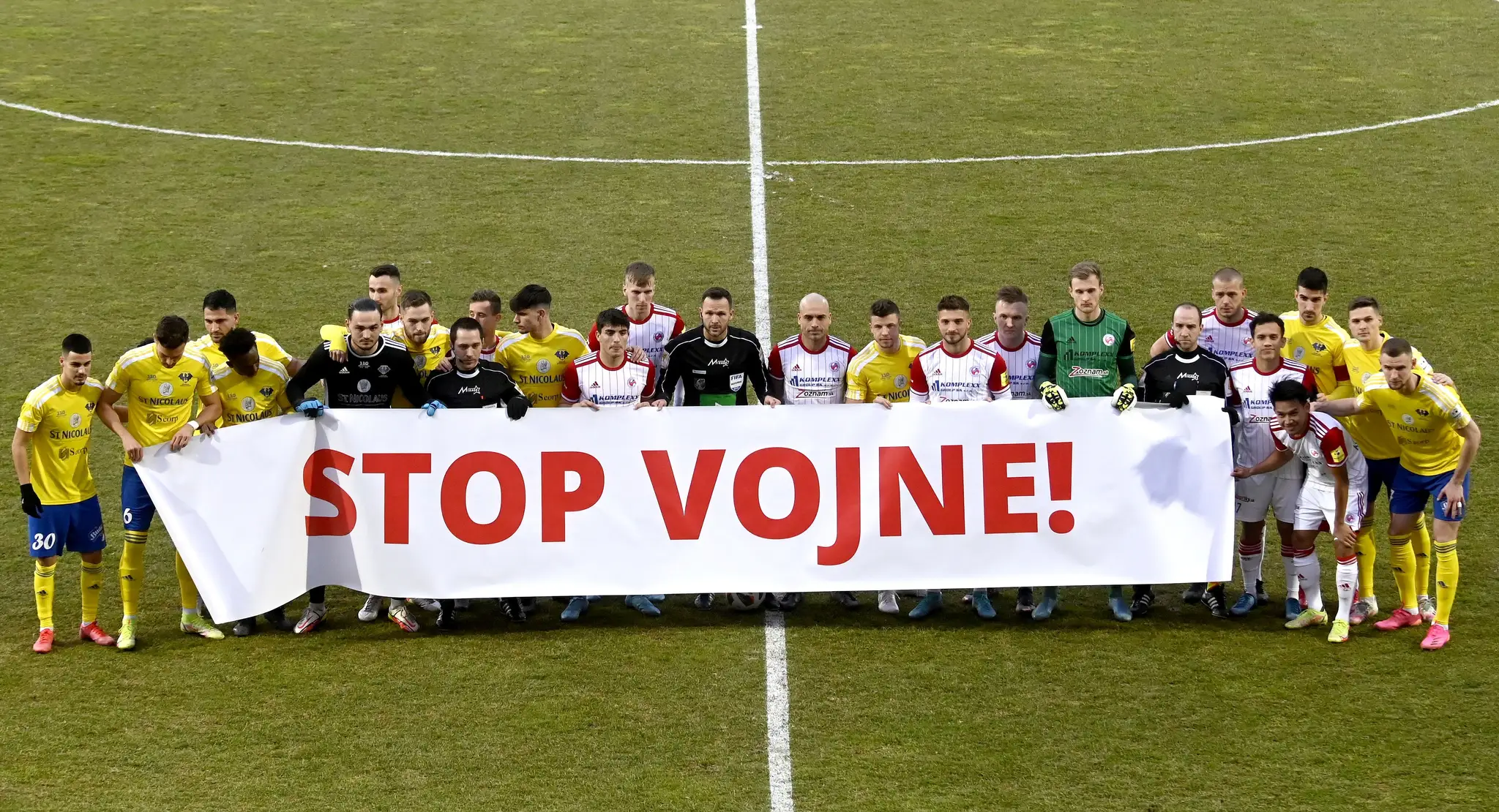 Hráči pózujú s transparentom Stop vojne pred zápasom Fortuna ligy medzi Michalovcami a Senicou