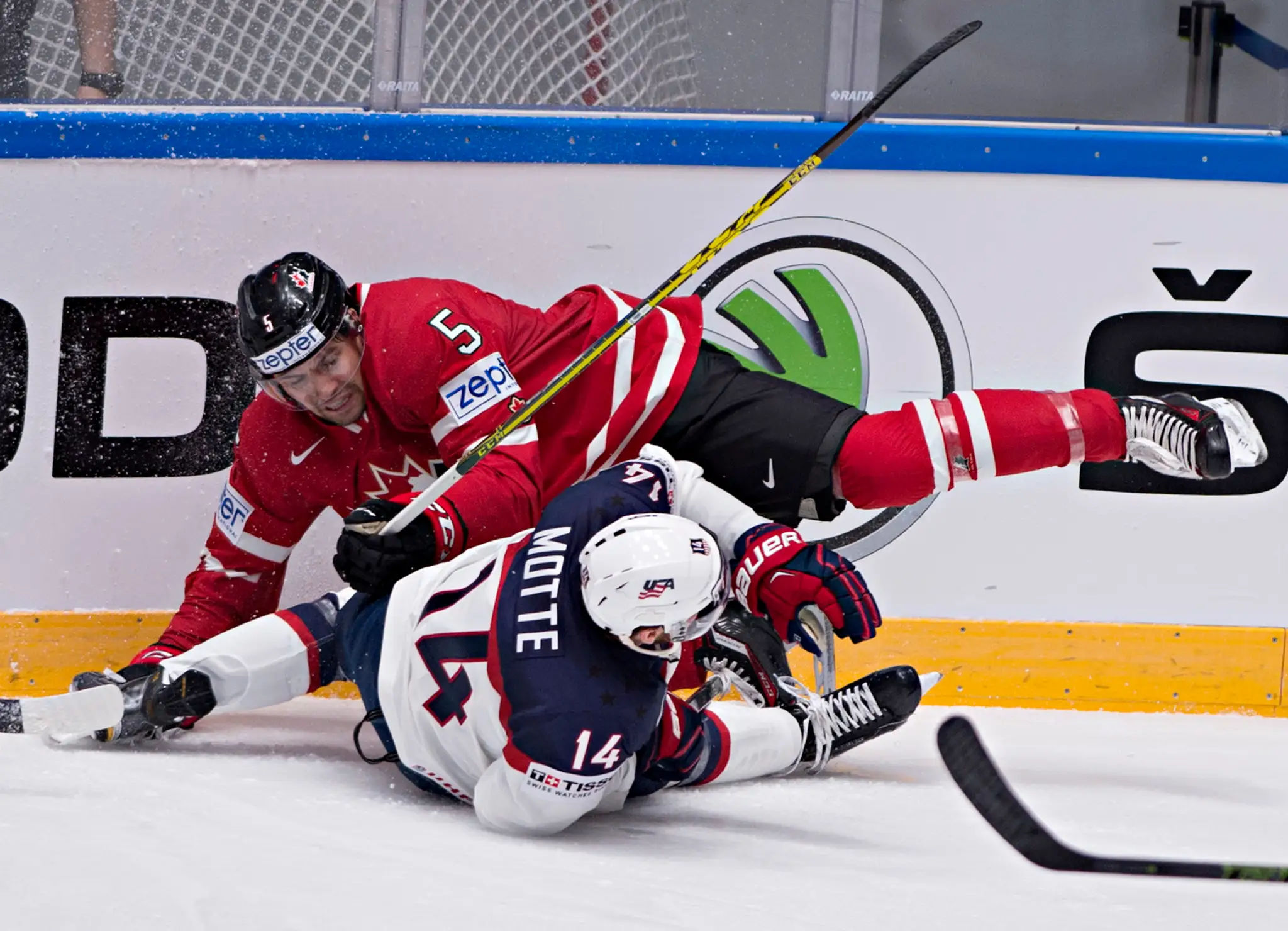 V ostrom súboji Kanaďan Cody Ceci (v červenom) proti Američanovi Tylerovi Mottemu vo vzájomnom dueli B-skupiny MS 2016 v Rusku.