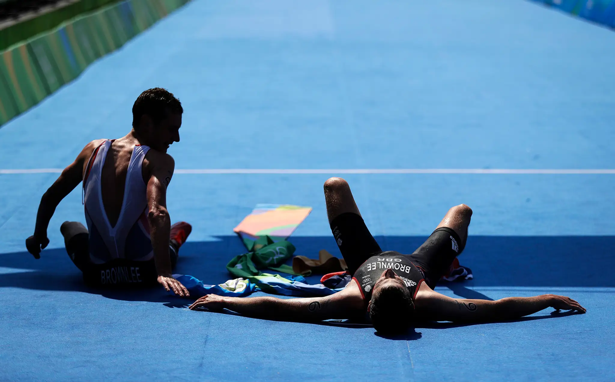 Vyčerpaný Alistair Brownlee a jeho brat Jonathan v cieli triatlonu na LOH v Riu.