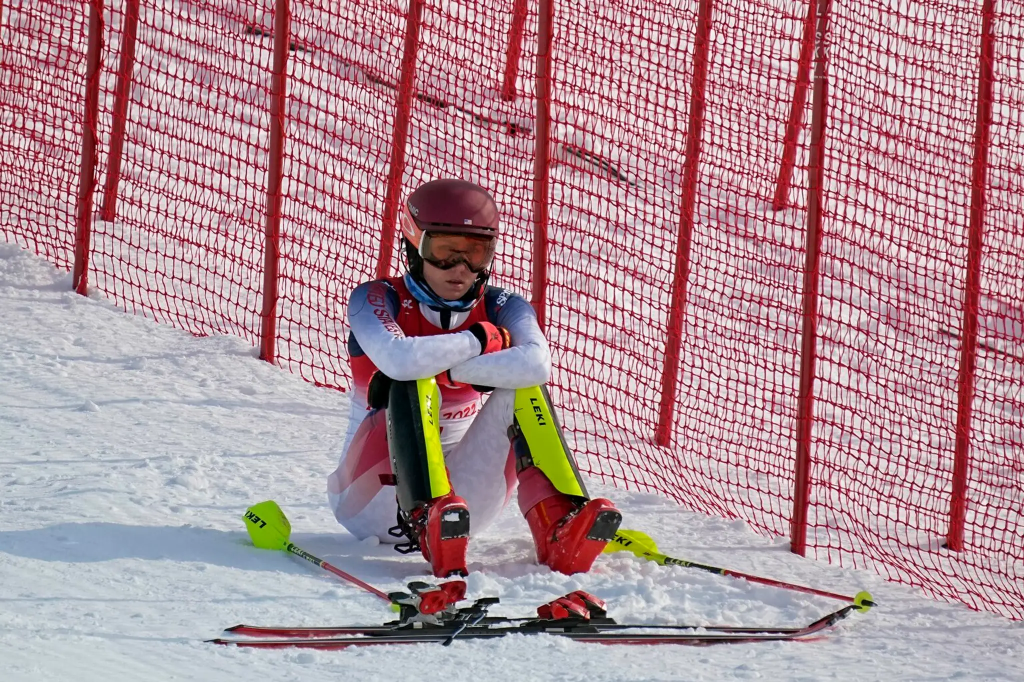 Mikaela Shiffrinová sedí na trati po tom, ako vypadla v 1.kole slalomu žien.