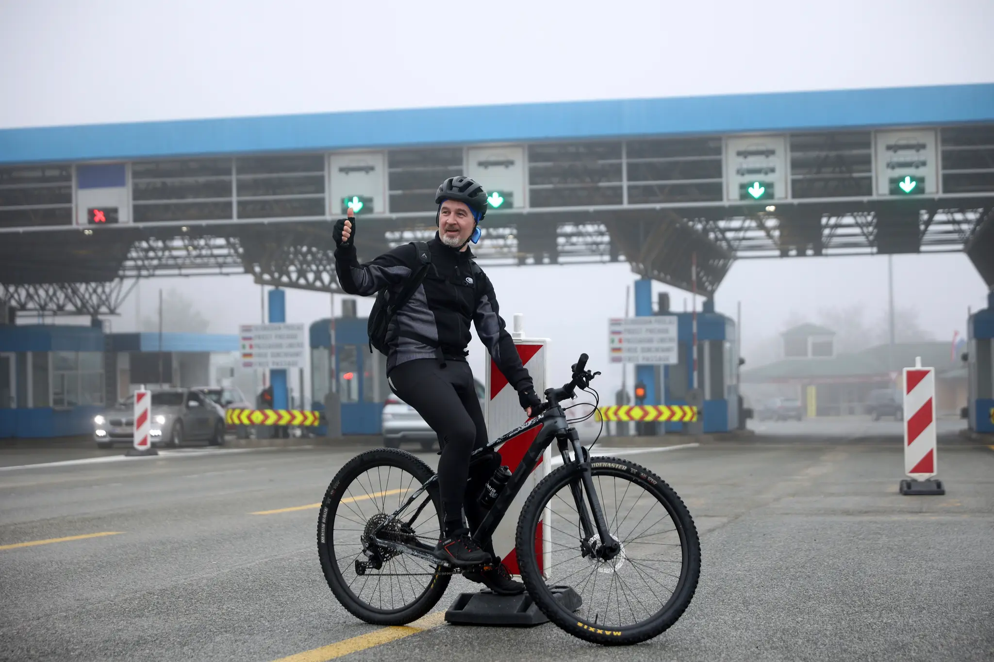 Cyklista Goran Lončar sa fotí po tom, čo po prvý raz bez zastavenia prešiel cez chorvátsko-slovinský hraničný priechod Rupa v nedeľu 1. januára 2023.