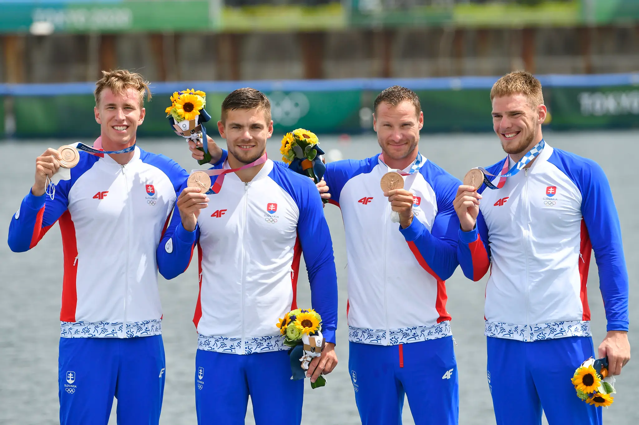 Slovenskí rýchlokanoisti zľava Samuel Baláž, Denis Myšák, Erik Vlček a Adam Botek sa tešia z bronzu na OH v Tokiu.