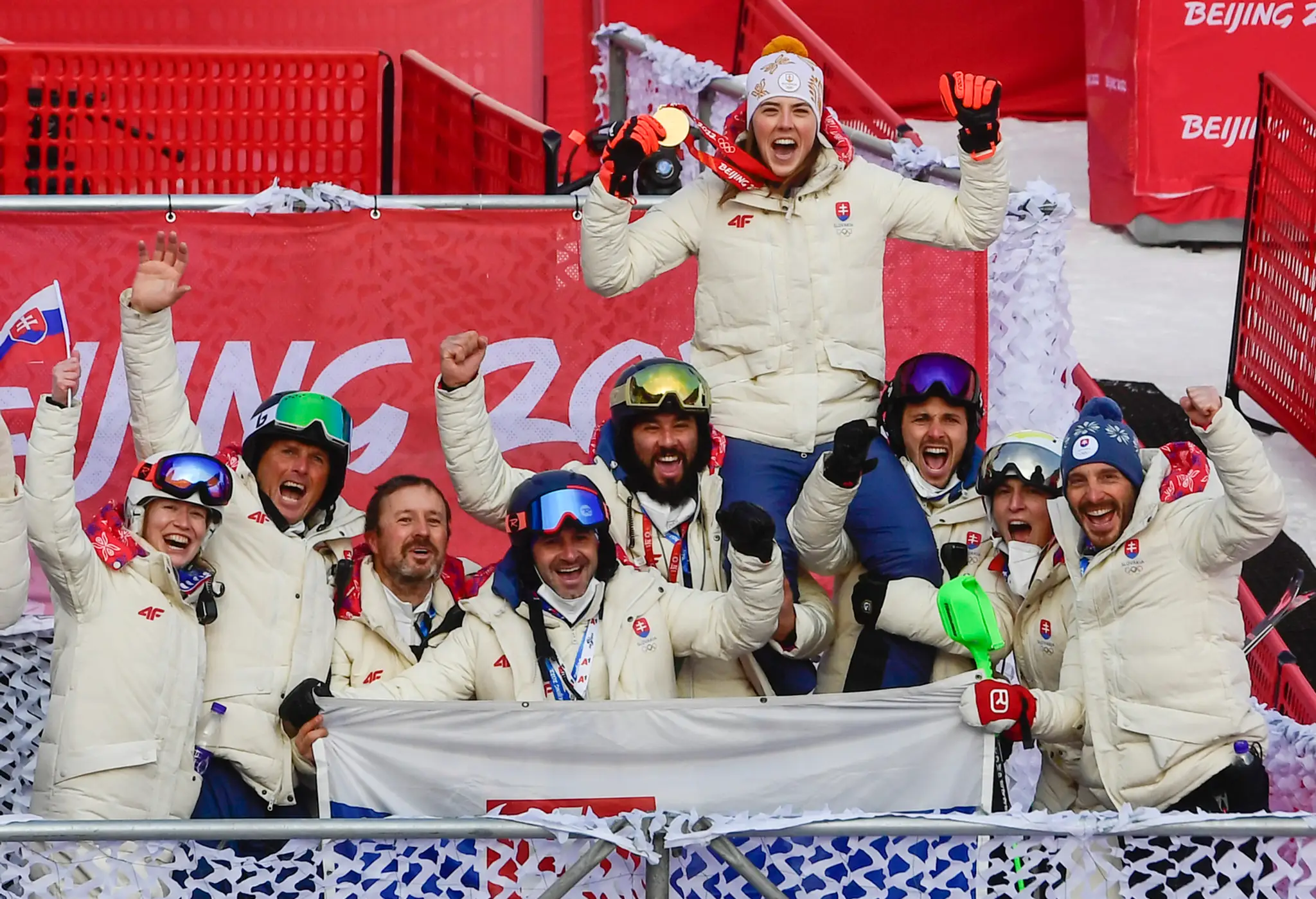 Slovenská lyžiarka Petra Vlhová oslavuje s tímom po tom, ako získala zlato v slalome na ZOH 2022.