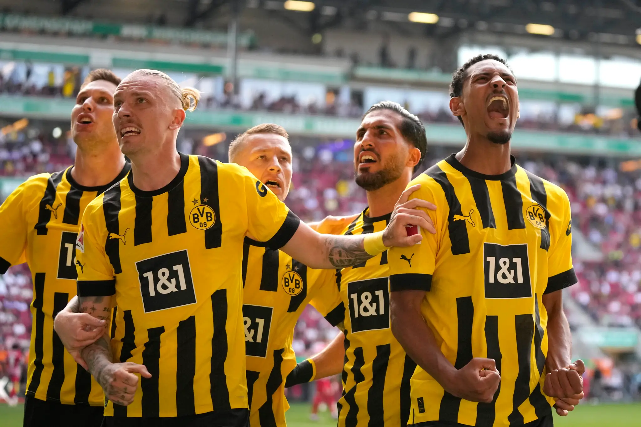 Hráč Dortmundu Sebastien Haller (vpravo) oslavuje gól so spoluhráčmi.