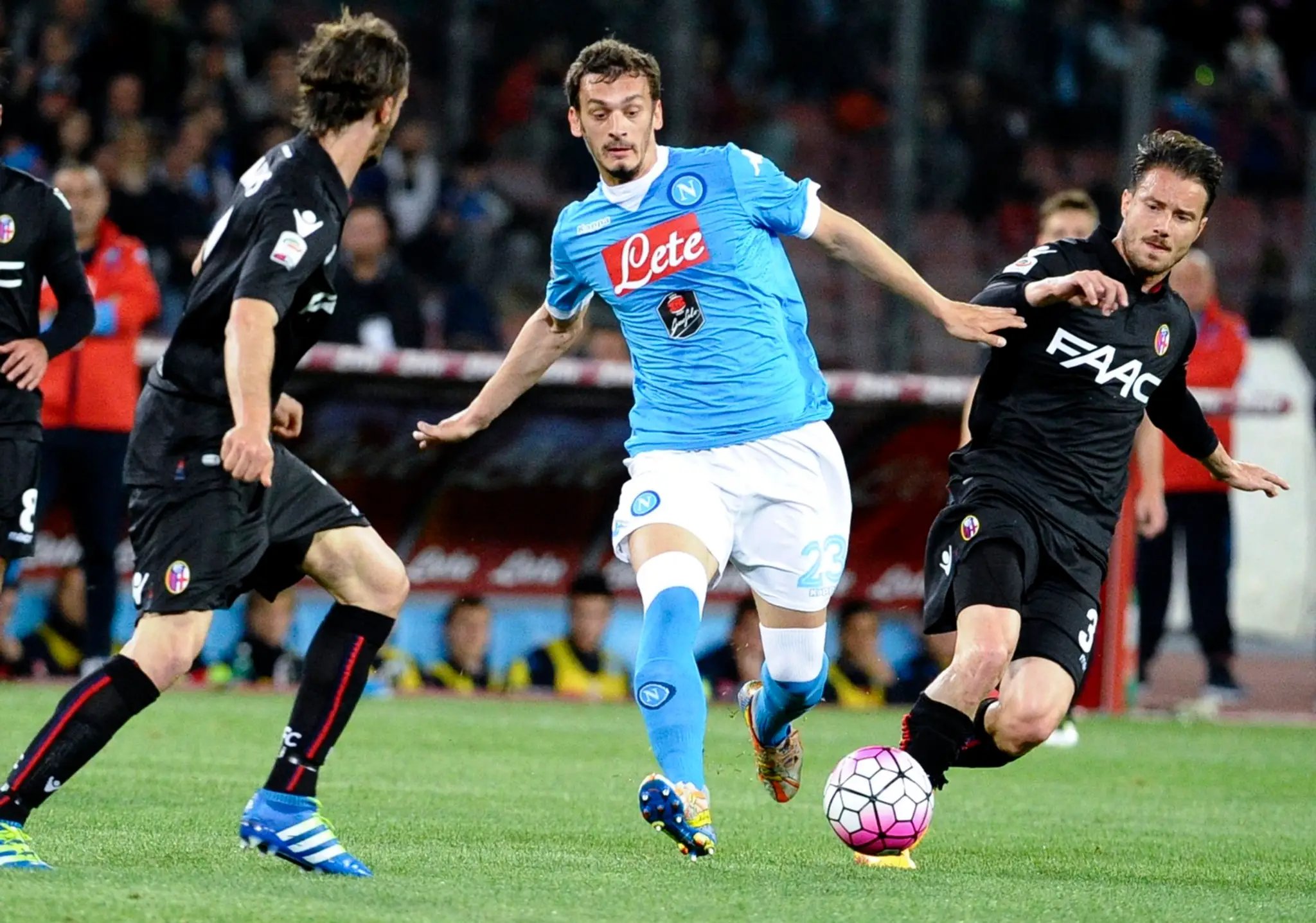 Hráč Neapolu Manolo Gabbiadini (v strede) v súboji s Matteom Brighim z Bologny (vpravo)