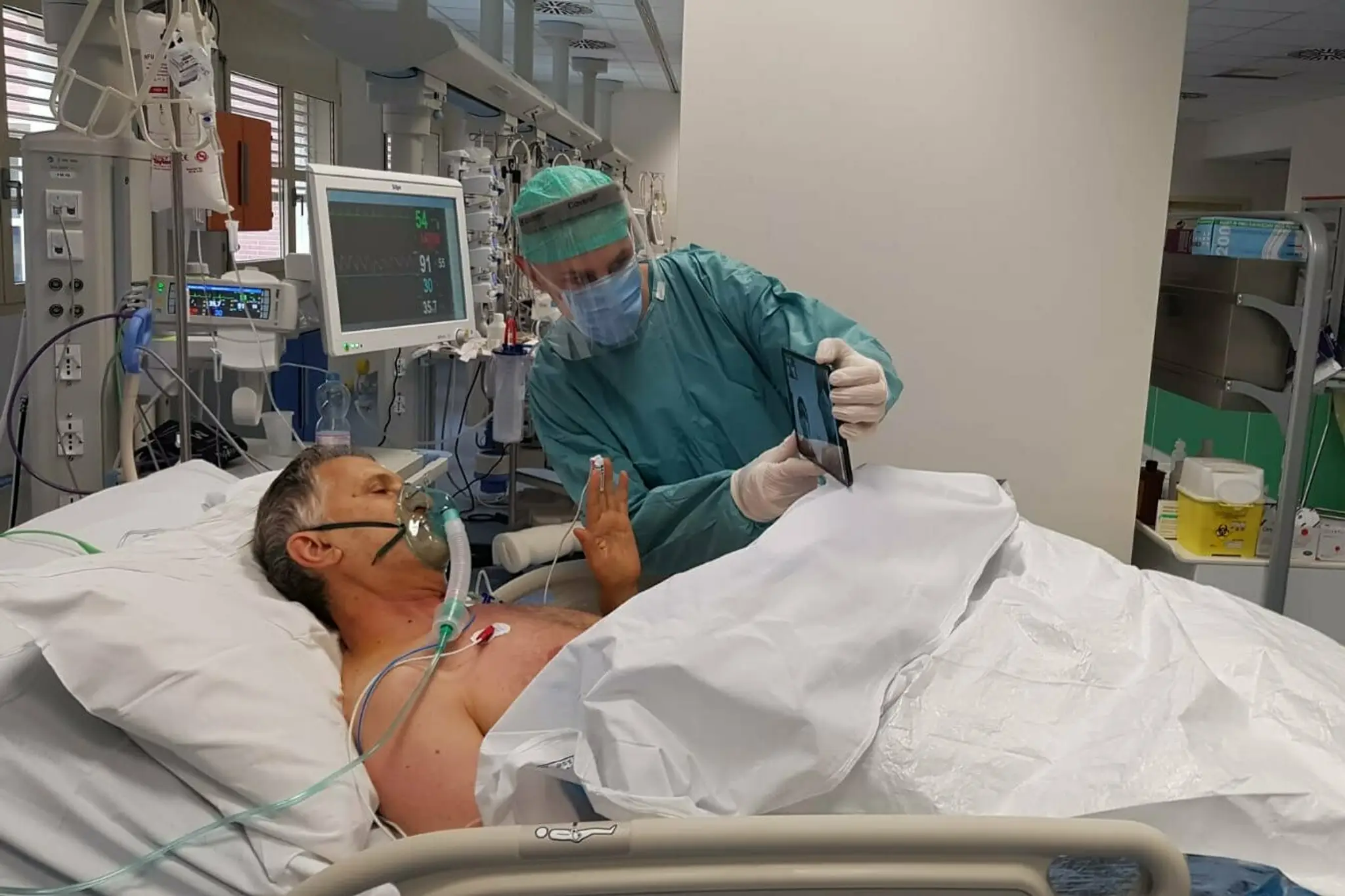 Pacient s  ochorením COVID 19 sa rozpráva s príbuznými počas hospitalizácie v nemocnici v Brescii.
