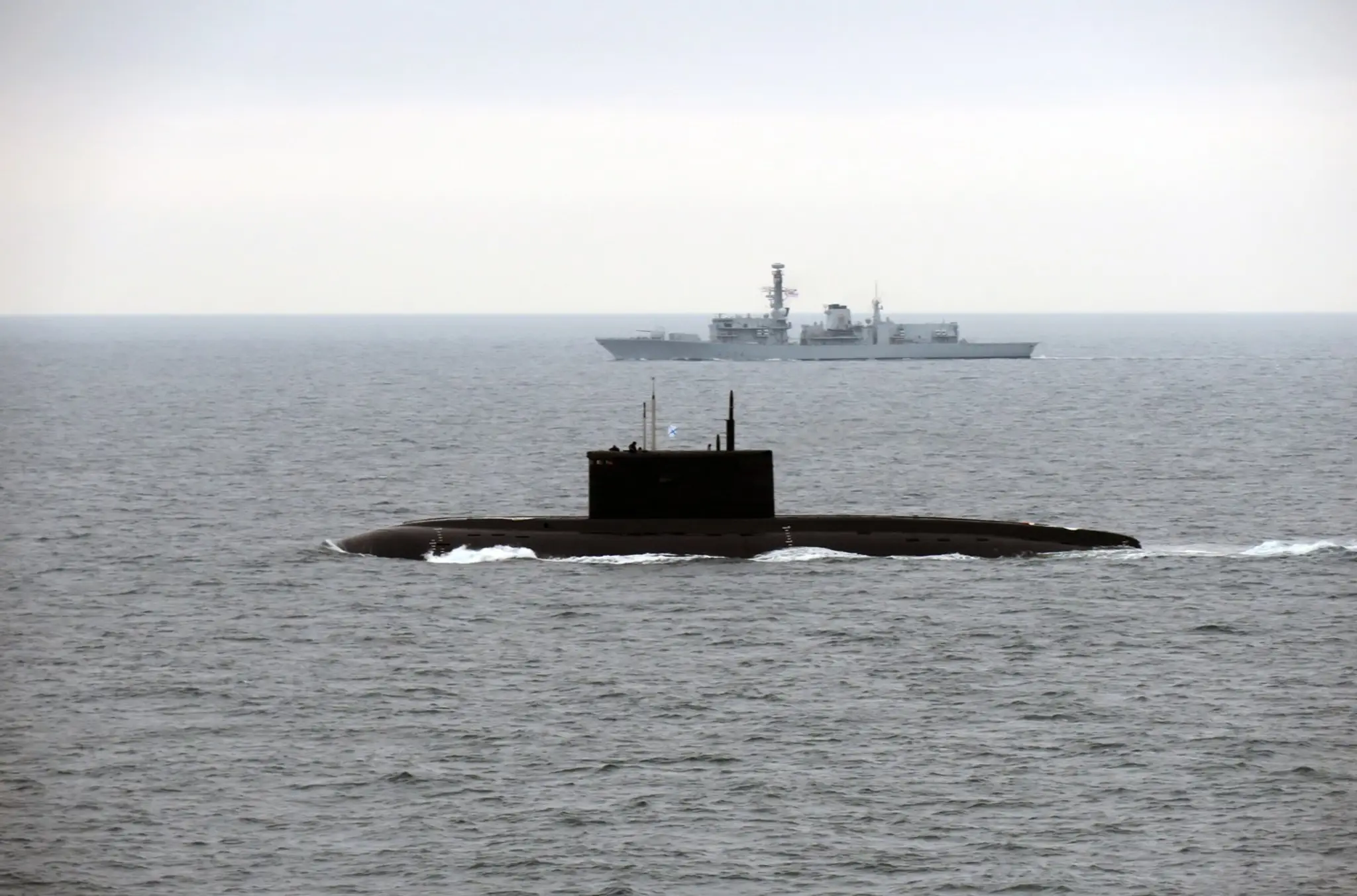 Ruská ponorka Novorosijsk sprevádzaná plavidlom kráľovského námorníctva HMS Iron Duke.