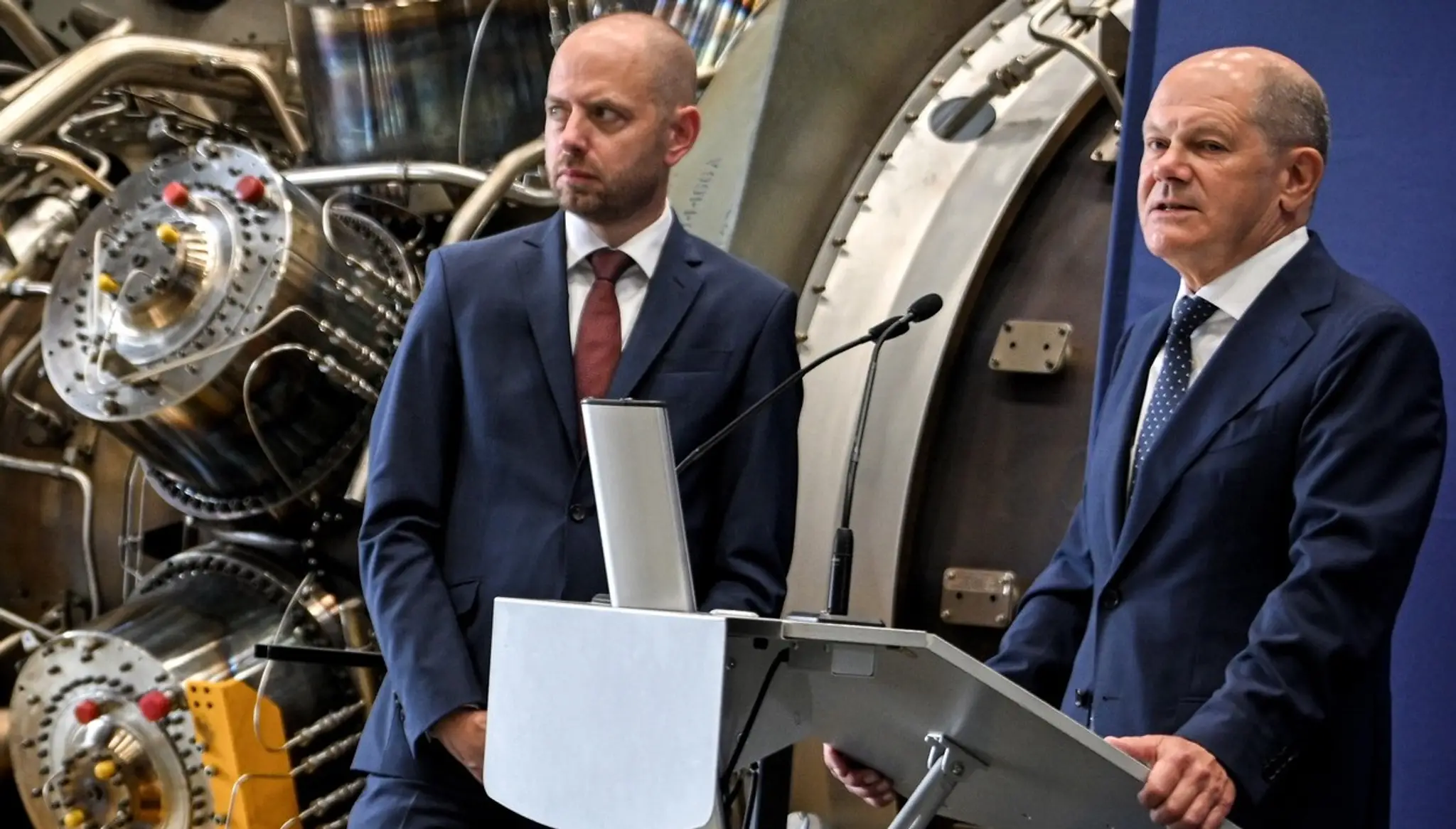 Nemecký kancelár Olaf Scholz (vpravo) a šéf Spoločnosti Siemens Energy Christian Bruch stoja pred turbínou. 