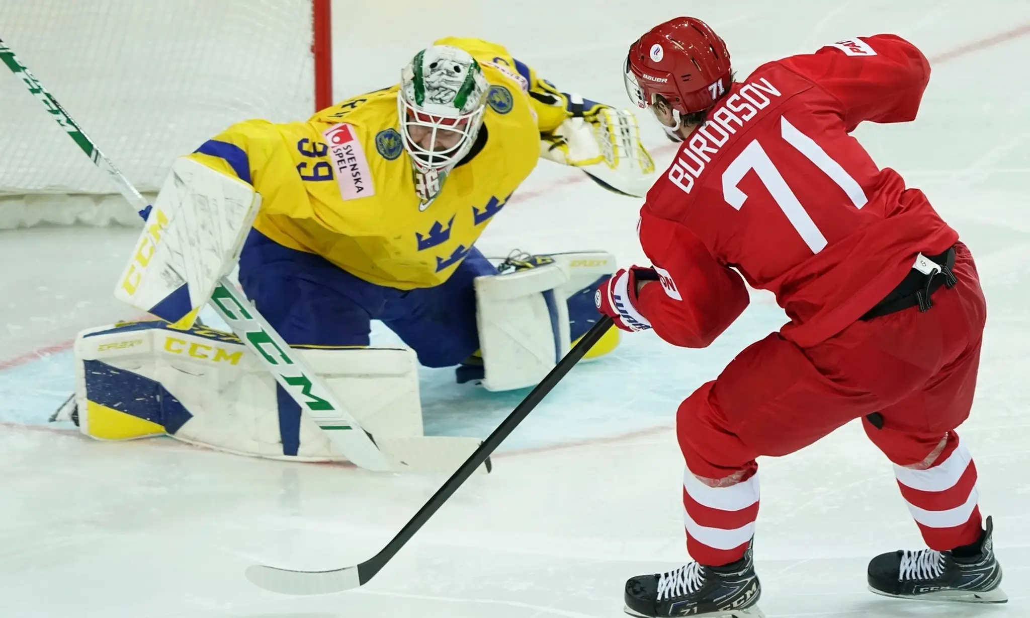 Na snímke vpravo ruský hráč Anton Burdasov, vľavo švédsky brankár Adam Reideborn v zápase základnej A-skupiny ROC (Rusko) - Švéd