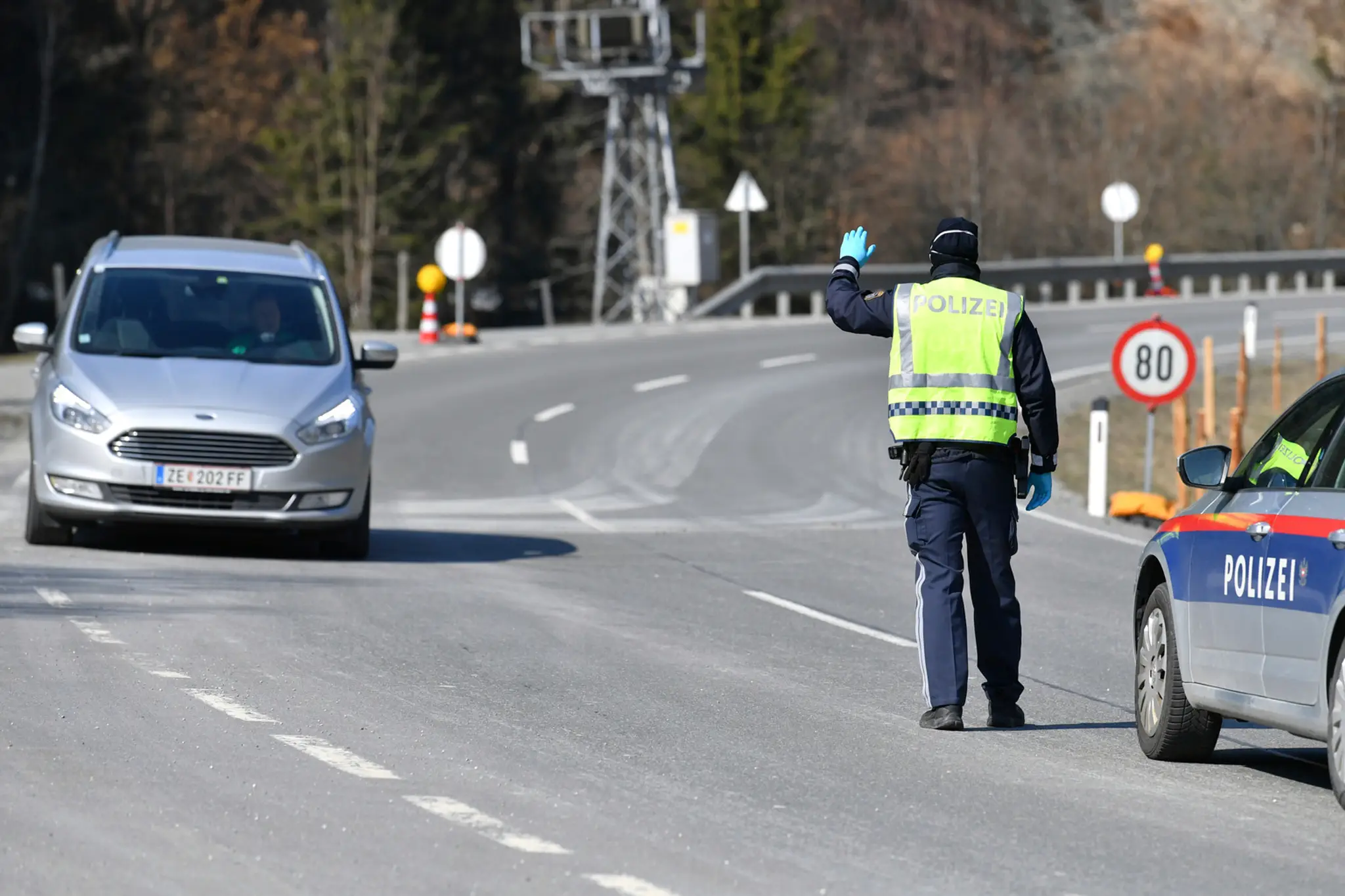 Rakúsky policajt zastavuje auto.