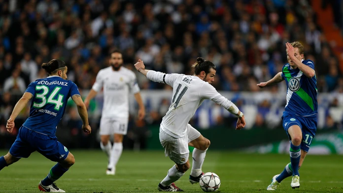 Gareth Bale z Realu Madrid v obkľúčení dvoch protihráčov Wolfsburgu v odvetnom dueli štvrťfinále Ligy majstrov.