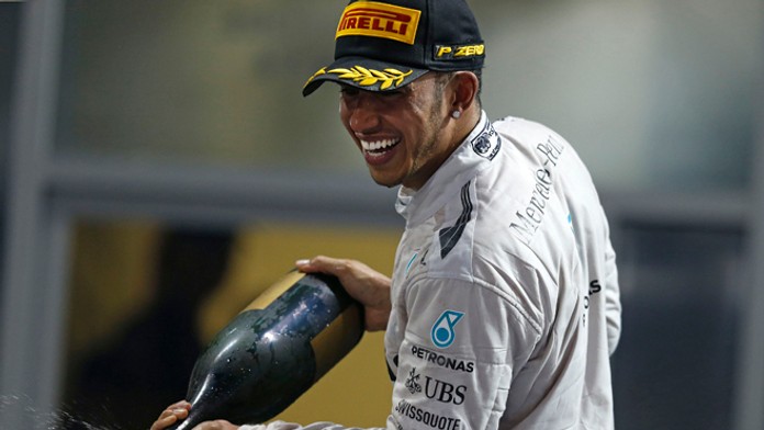 Lewis Hamilton oslavuje so šampanským zisk titulu majstra sveta.