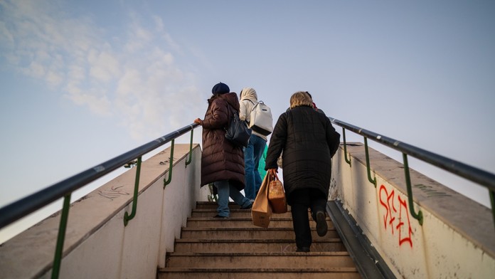 Ľudia stoja na schodoch 