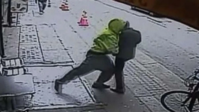 Chlap hádže okoloidúceho muža pod kamión.