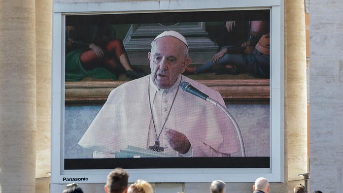 Veriaci sledujú pápeža Františka na celoplošnej obrazovke počas nedeľnej modlitby Anjel Pána.