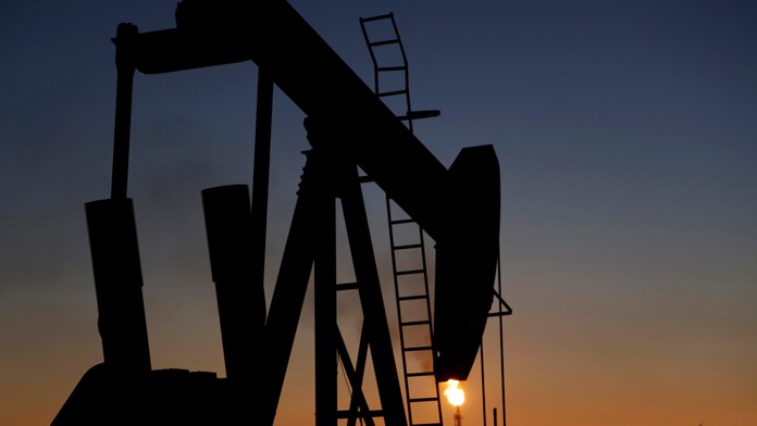 Na snímke ropné čerpadlo na ropných poliach počas východu Slnka v bahrajnskom Sachíre.