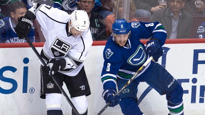  obranca Kings Andrej Sekera (vľavo) a hráč Canucks Chris Tanev (vpravo) v súboji o puk.