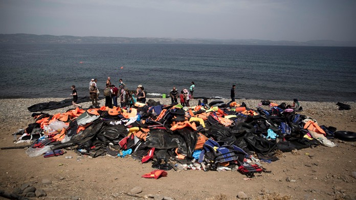 Pohľad na záchranné vesty na pláži krátko po vylodení sýrskych migrantov z nafukovacieho člna spolu s ostatnými migrantmi na sev
