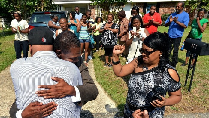 Na archívnej snímke z roku 2014 nevlastní bratia Leon Brown a Henry McCollum sa objímajú po prepustení z väzenia.