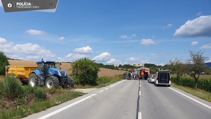 Policajti dokumentujú dopravnú nehodu traktora a osobného auta.