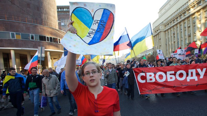 Dievča s transparentom "Sme za mier " počas pochodu za mier na Ukrajine v Moskve. 