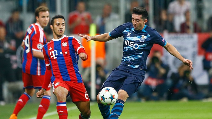 Hráč Bayernu Mníchov Thiago (vľavo) bojuje o loptu s Hectorom Herrerom z FC Porto.
