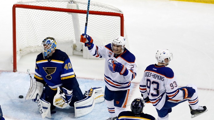 Hokejisti Edmontonu Oilers Ryan Nugent-Hopkins (93) a Slovák Andrej Sekera (druhý zľava) sa tešia po strelení víťazného gólu.