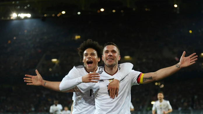 Lukas Podolski oslavuje so spoluhráčom Leroyom Saném svoj gól.