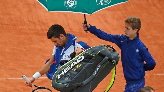 Svetová jednotka Novak Djokovič odchádza z kurtu po prerušení zápasu pre dážď.