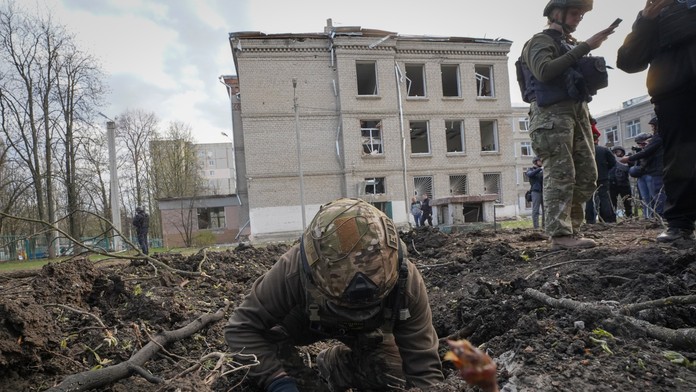 Vojenský expert skúma miesto ruského bombového útoku, pri ktorom zahynulo niekoľko ľudí v meste Charkov na východe Ukrajiny.